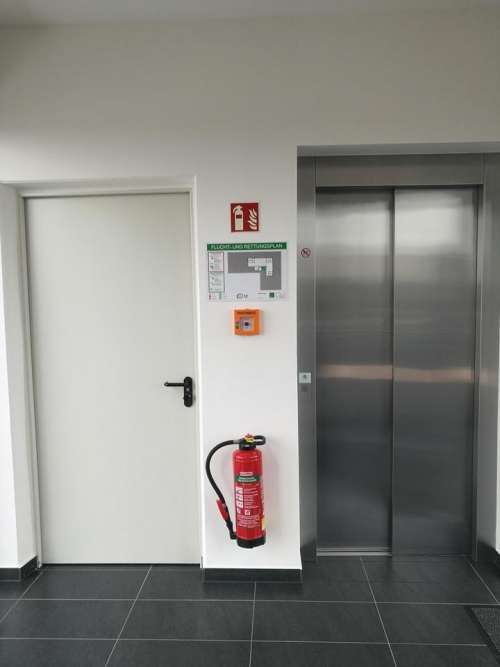 Elevator exit hallway fire extinguisher interior 