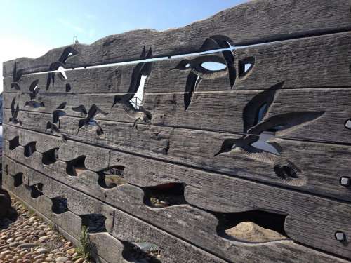 Carved wood fence seagulls birds seaside