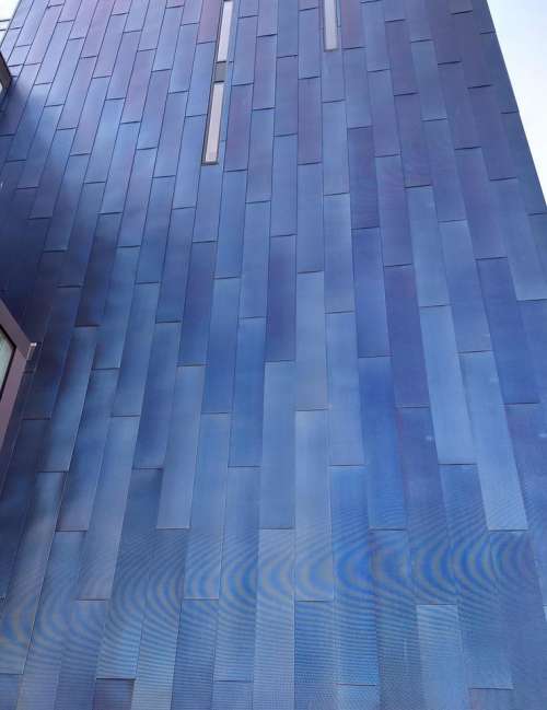 blue study in blue cladding high rise building