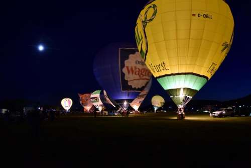 Hot air balloon preparation inflation start night glow