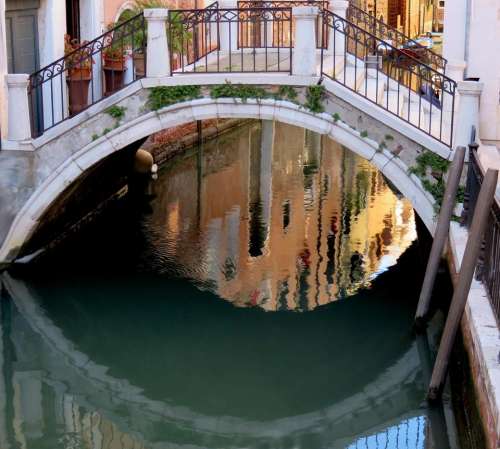 Venice canal bridge reflection water