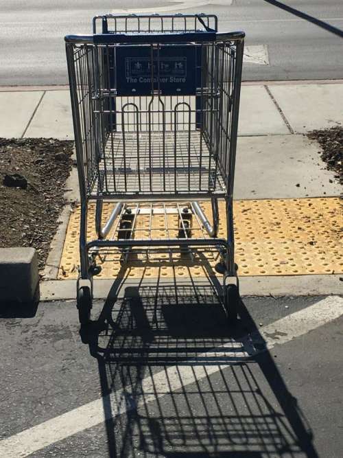 shopping cart cast shadow street parking lot 