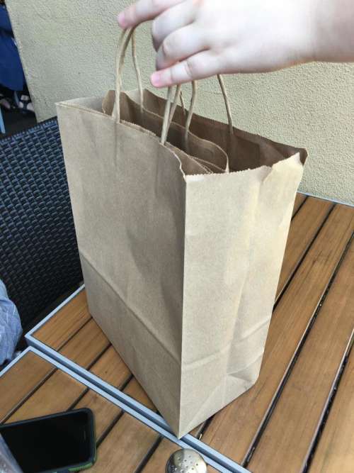 brown paper shopping bag table