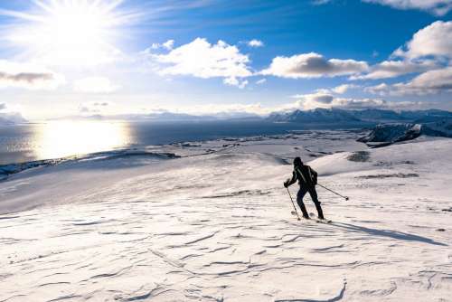 Man Skiing on Snowy Mountains of Norway