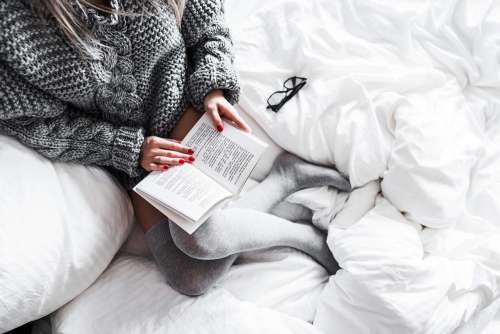 Relaxed Woman Reading in Bed