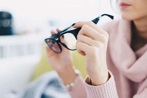 Woman Trying Eyeglasses in Optical Store