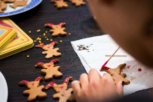 Girl decorating easter gingerbread cookies