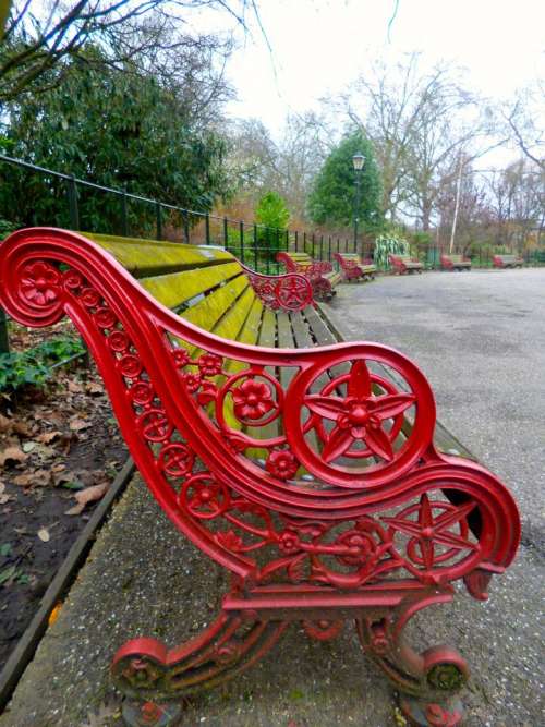 red bench ornate iron park