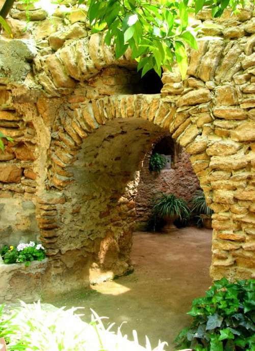 stone wall arch opening garden
