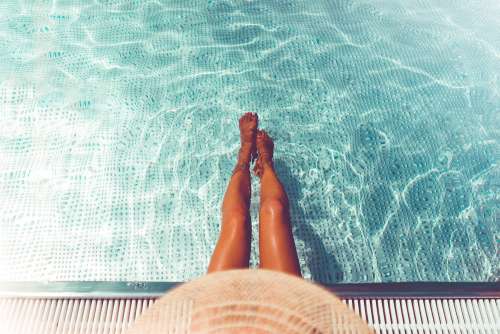 Woman Legs in Swimming Pool