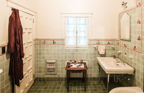 A Silk Robe Draped Over A Bathroom Door Photo