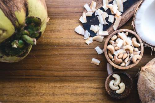 Cashew nuts and coconut on a wooden table
