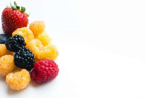 Detail of colorful healthy fresh berries on a white background