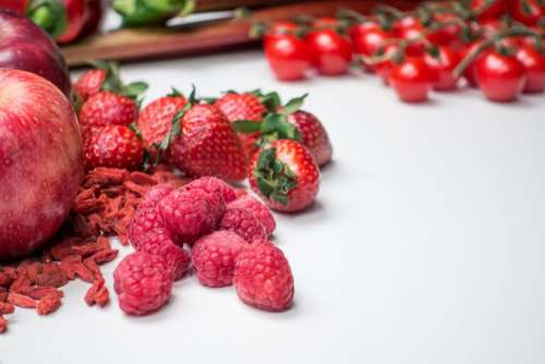 Fresh raspberries with other red fruit and vegetables