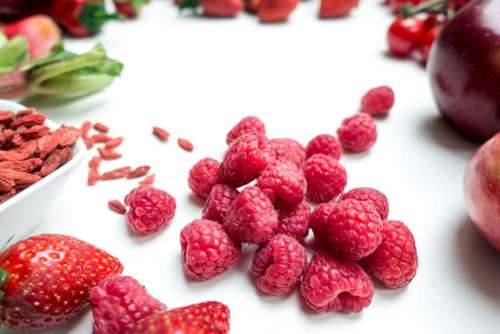 Fresh raspberries with other red fruit and vegetables