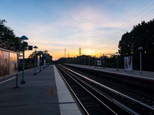 Sunset Over Train Platform and Tracks