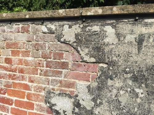 Brick wall plaster crumbling background old