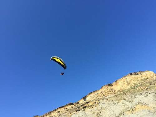 Paraglider sky blue flying gliding