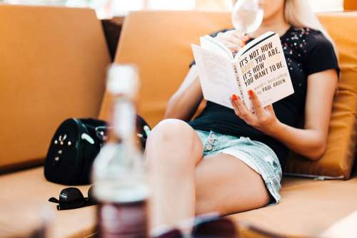 Woman Reading a Book in a Café