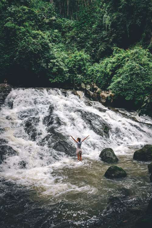 Young Woman Enjoying Waterfall in Bali