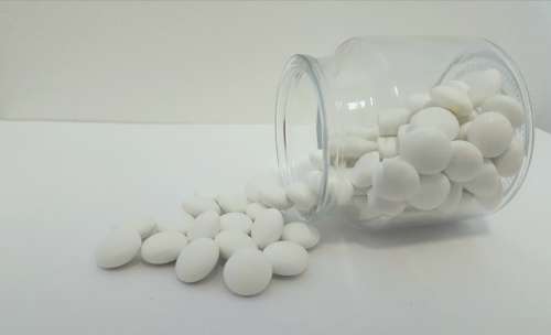 White Jar Glass Chocolate Lentils Candy Pouring