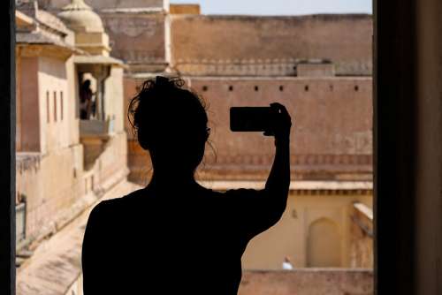 Silhouette of a Tourist Girl Taking a Selfie