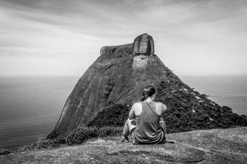 A Climber Sits Atop A Hill Surveilling Her Next Challenge Photo