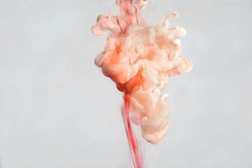 A Cloud Of Pink Paint In Water Photo