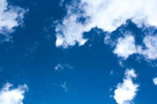 Bright Blue Sky Dotted With Fluffy White Clouds Photo