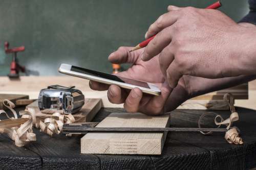 Checking Phone For Woodwork Instructions Photo