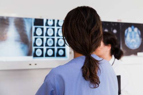 Doctor And Nurse Examine X-Rays Photo