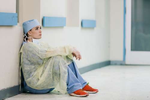 Doctor Sits Against Wall Photo