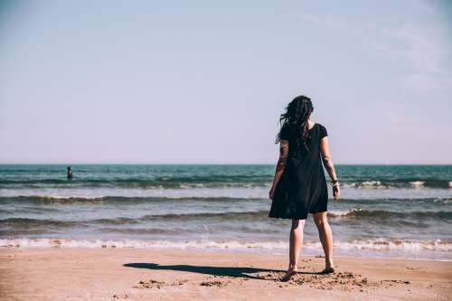 Woman In Black Dress At Beach Photo