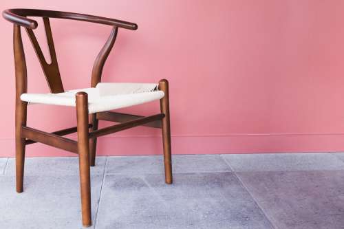 Wooden Chair By Pink Wall Photo