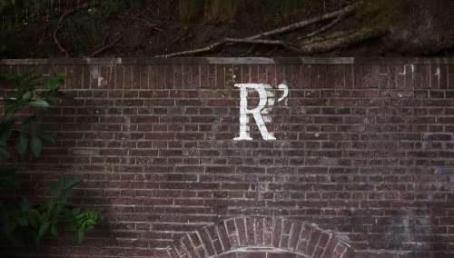 r letter brick wall urban