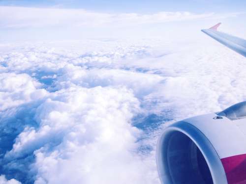 airplane clouds sky flight travel