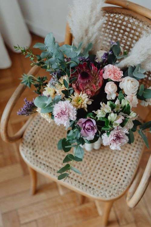 Beautiful bouquet of flowers on a wooden chair