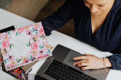 Happy casual beautiful woman working on a laptop