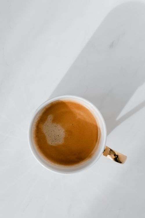 Cup of coffee on white marble