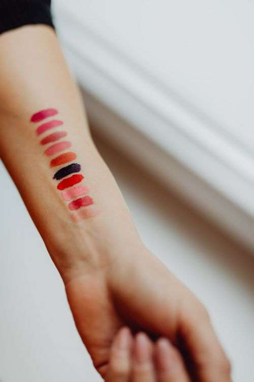 Lipstick swatches on woman hand
