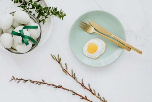 Easter flat lay with eggs on a white marble