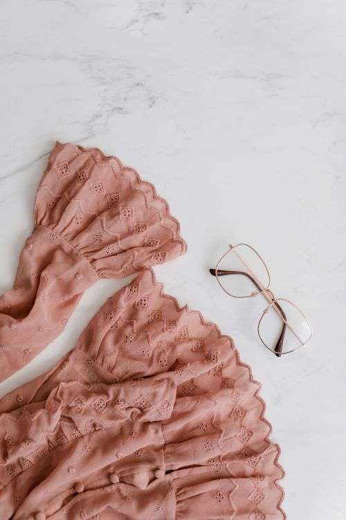 Blouse in pale pink colour made of thin chiffon with frills