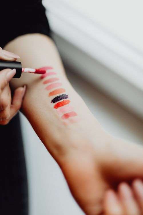 Lipstick swatches on woman hand