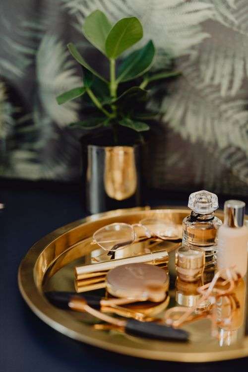 Makeup essentials on a golden tray