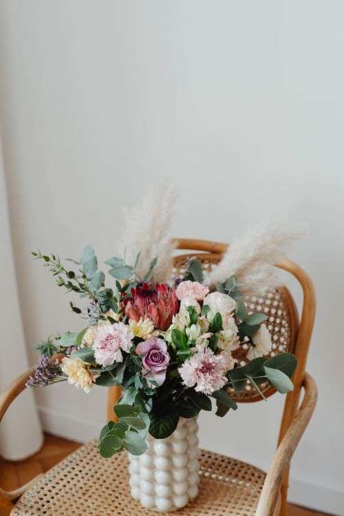Beautiful bouquet of flowers on a wooden chair