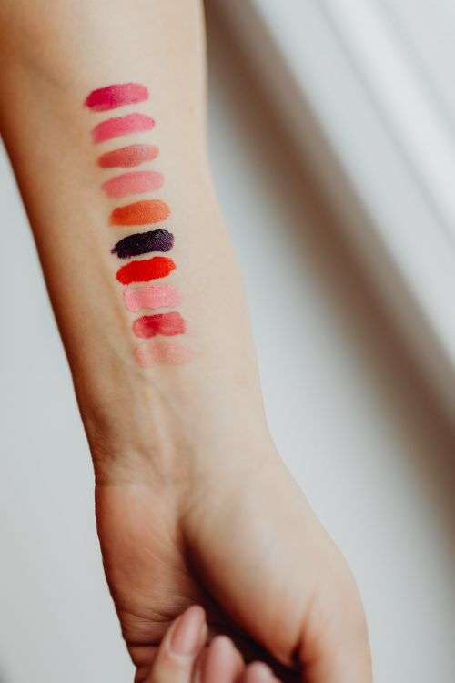 Lipstick swatches on woman hand