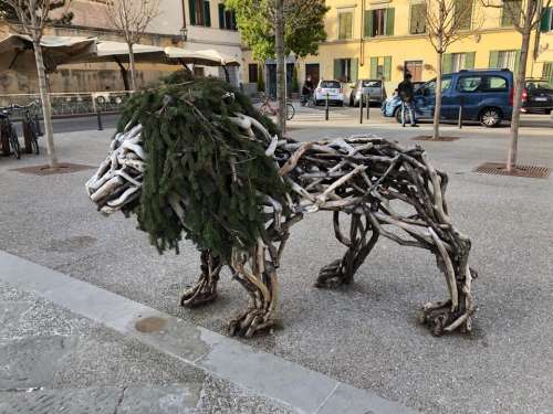 lion sculpture sticks branches