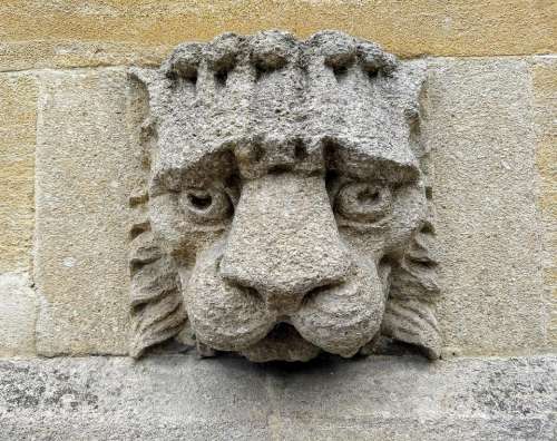 sad lion gargoyle stone mason