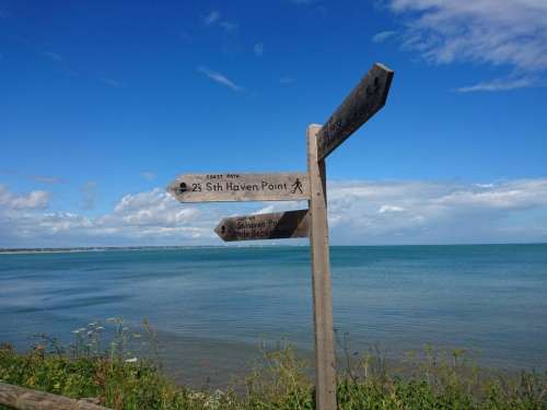 signpost wood directions sea clifftop