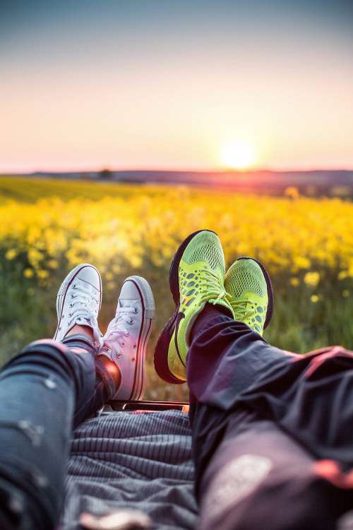 Young Couple Enjoying Sunset in a Car Trunk